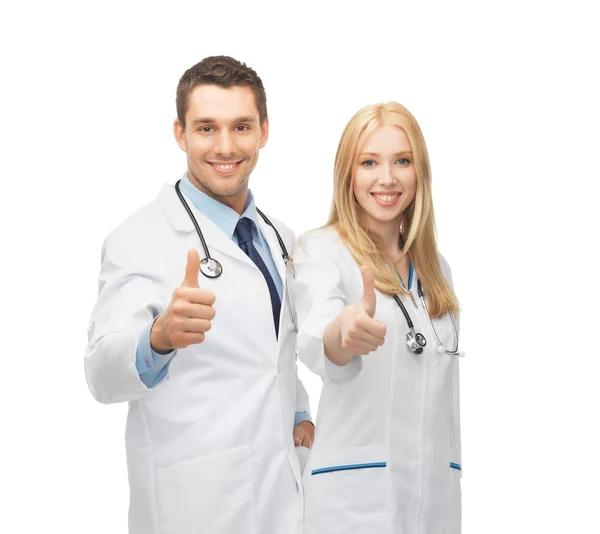 Young team of two doctors showing thumbs up — Stock Photo, Image