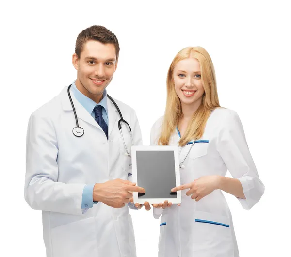 Young doctors pointing at tablet pc — Stock Photo, Image