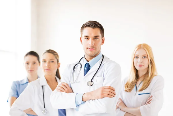 Male doctor in front of medical group — Stock Photo, Image