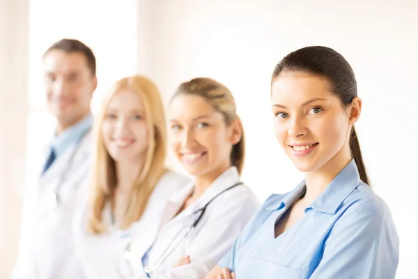 Female doctor in front of medical group — Stock Photo, Image