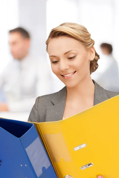 Young attractive businesswoman with folders — Stock Photo, Image