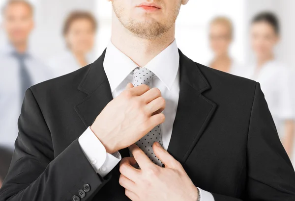 Man adjusting his tie — Stock Photo, Image