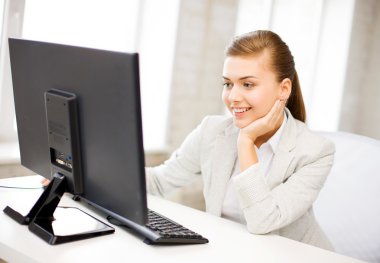 Businesswoman with computer in office clipart