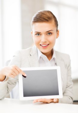 Businesswoman with tablet pc in office clipart