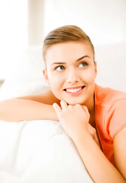 Mulher sorridente deitada no sofá — Fotografia de Stock