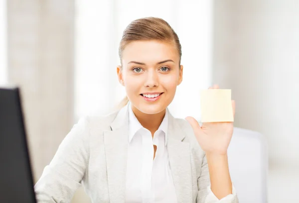 Empresária sorridente mostrando nota pegajosa — Fotografia de Stock