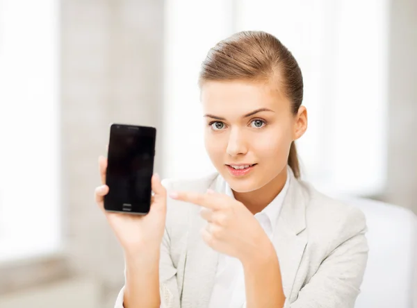 Businesswoman with smartphone in office — Stock Photo, Image