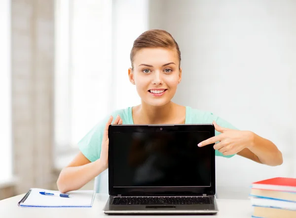 Smiling student girl with laptop at school — Stock Photo, Image