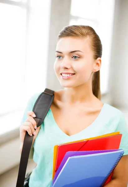 Öğrenci kız okul çantası ve renkli klasörler — Stok fotoğraf