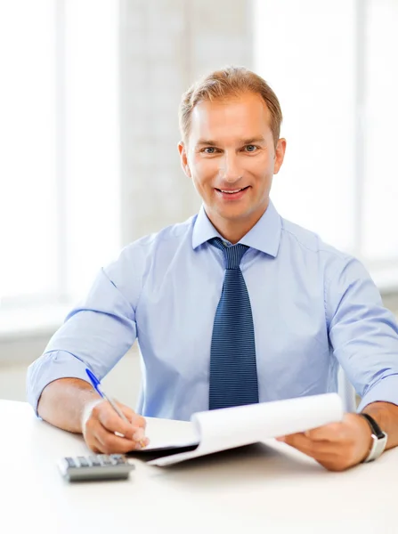 Businessman with notebook and calculator Stock Photo