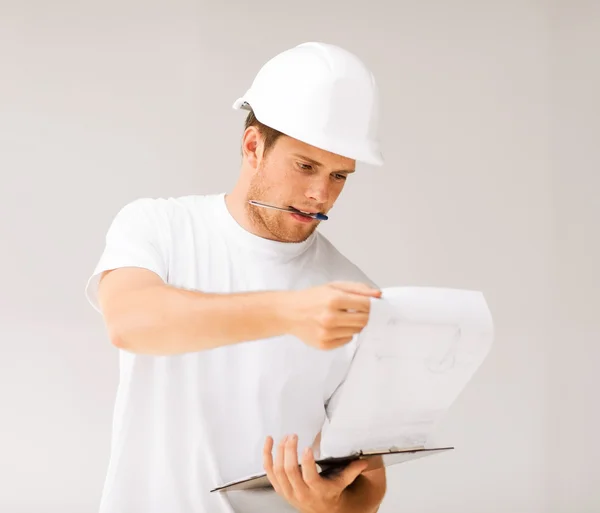 Male architect looking at blueprint — Stock Photo, Image