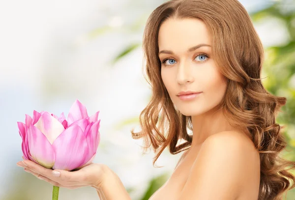 Lovely woman with lotos flower — Stock Photo, Image