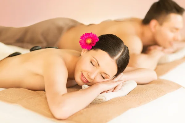 Couple in spa with hot stones — Stock Photo, Image