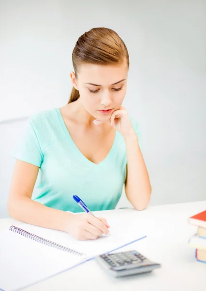 Student girl with notebook and calculator Royalty Free Stock Photos