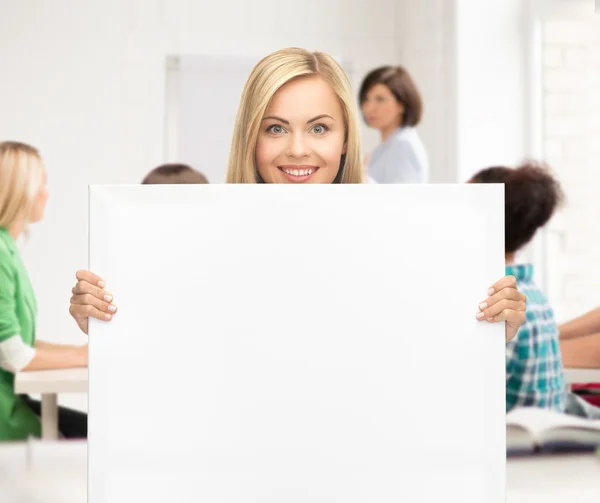Woman with white blank board at school — Stock Photo, Image