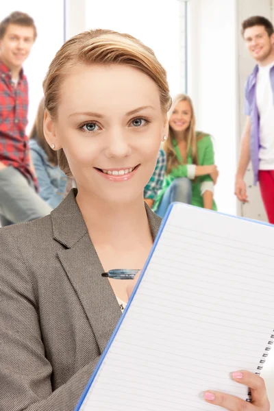 Teacher with big notepad at school — Stock Photo, Image