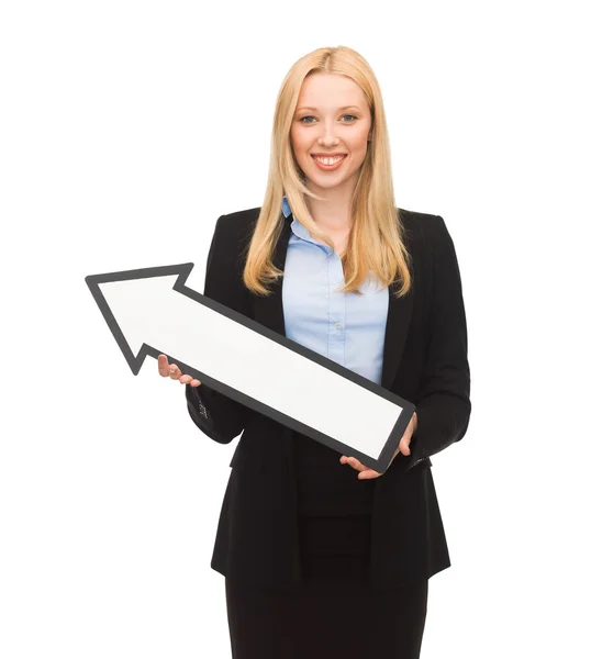 Smiling businesswoman with direction arrow sign — Stock Photo, Image
