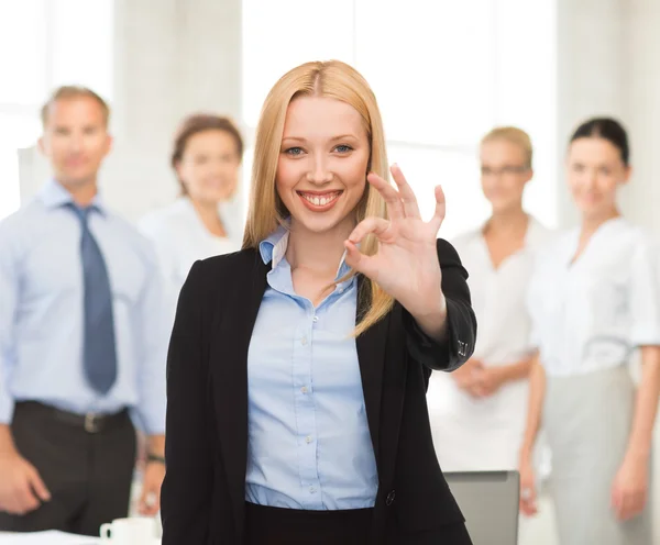 Young businesswoman showing ok sign Stock Image