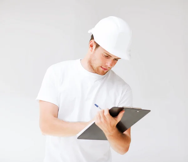 Male architect looking at blueprint — Stock Photo, Image