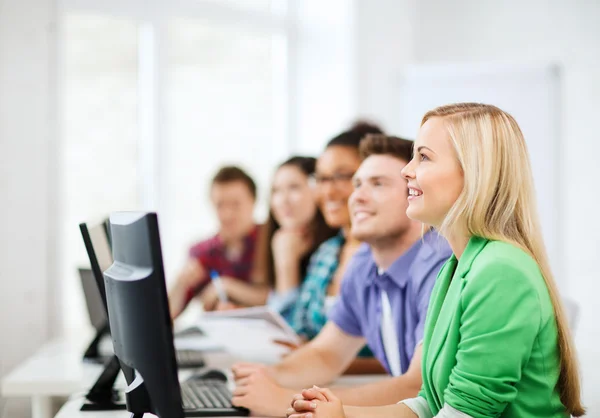 Students with computers studying at school — Stock Photo, Image