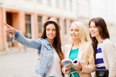Beautiful girls looking for direction in the city clipart