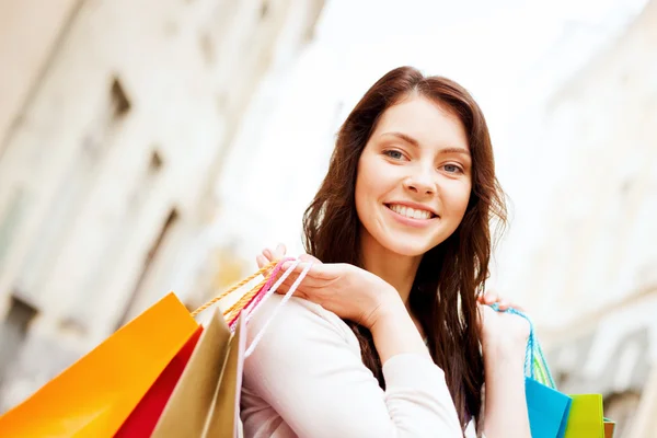 Woman with shopping bags in ctiy Stock Picture