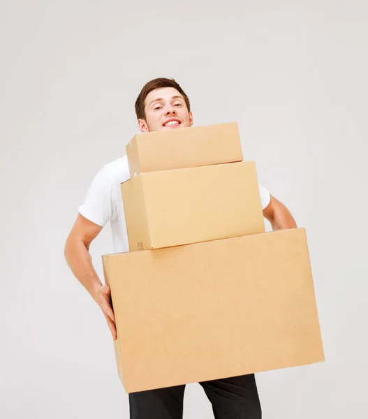 Young man carrying carton boxes — Stock Photo, Image