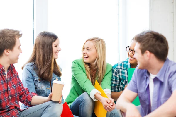 Students communicating and laughing at school — Stock Photo, Image