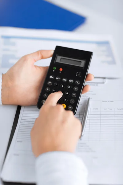 Woman hand with calculator and papers — Stock Photo, Image