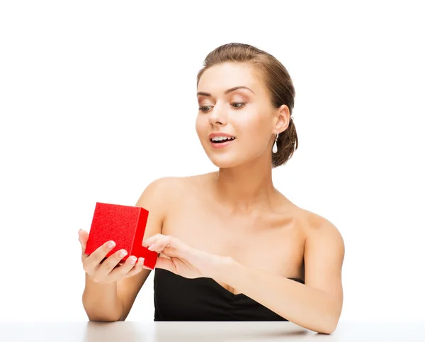 Woman with diamond earrings and gift box Stock Picture