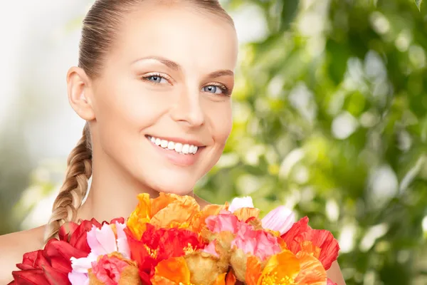 Ung kvinna med bukett blommor — Stockfoto