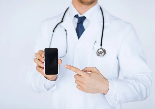 Doctor pointing at smartphone — Stock Photo, Image