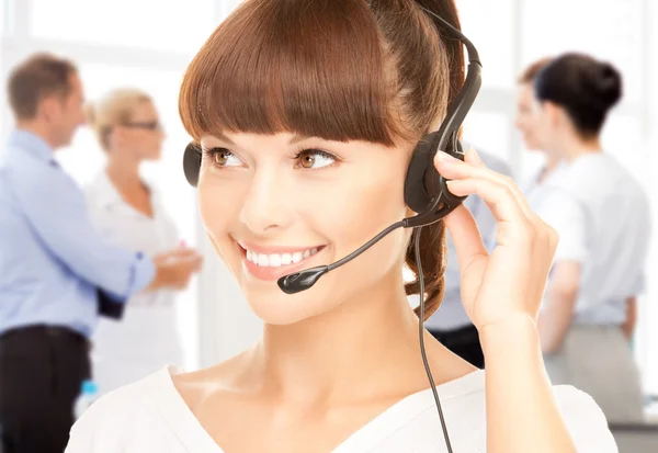 Helpline operator with headphones in call centre — Stock Photo, Image