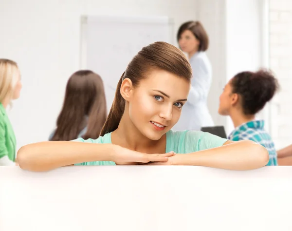 Smiling student girl with white blank board — Stock Photo, Image