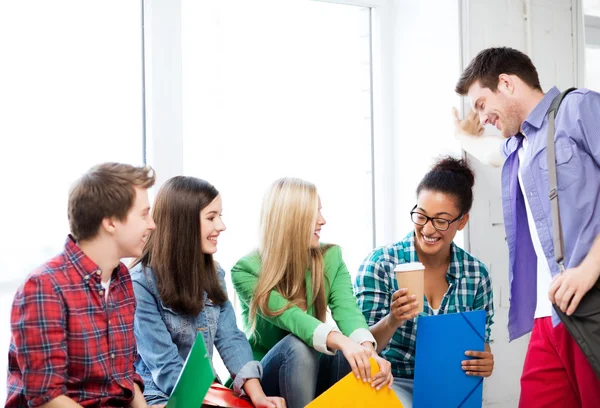 Students communicating and laughing at school — Stock Photo, Image