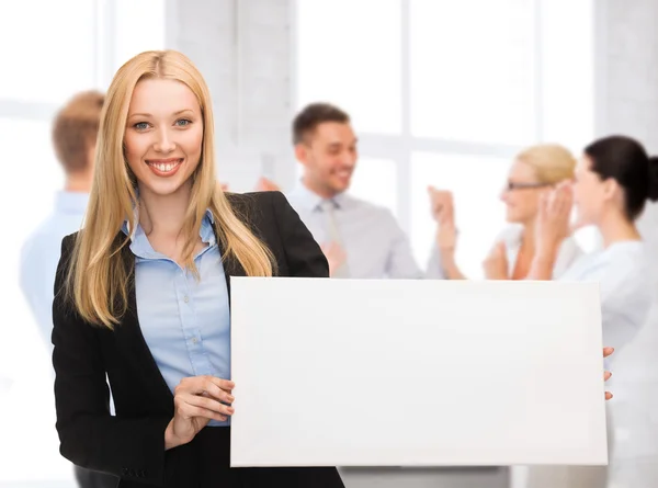 Businesswoman with white blank board Stock Picture
