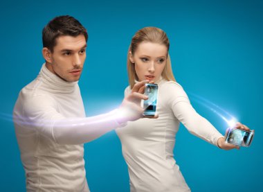 Futuristic man and woman working with gadgets clipart