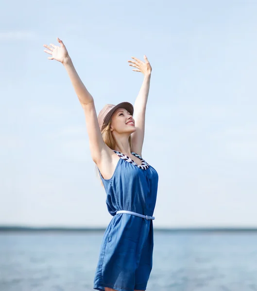 Girl with hands up on the beach — Stock Photo, Image