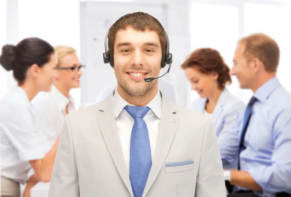 Helpline operator with headphones in call centre — Stock Photo, Image