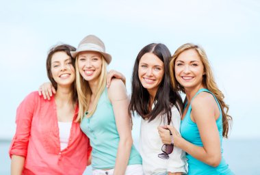 Group of girls chilling on the beach clipart