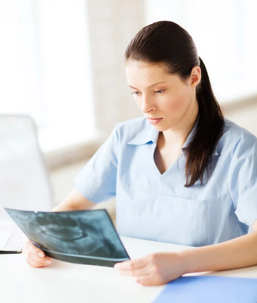 Doctor or dentist looking at x-ray — Stock Photo, Image