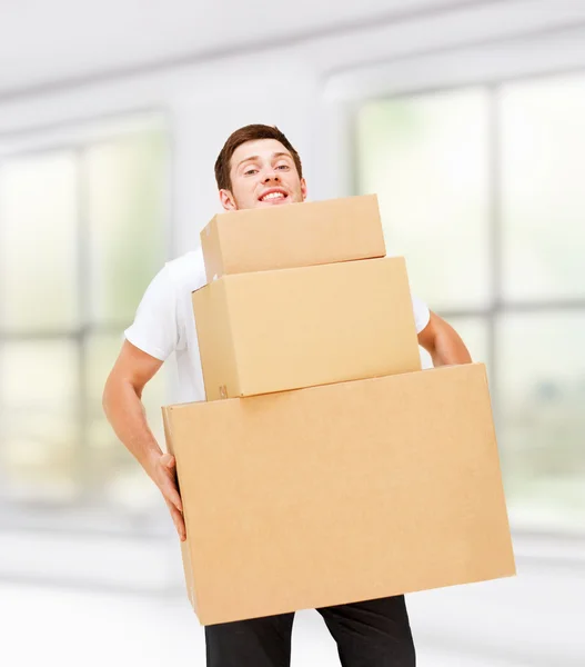 Young man carrying carton boxes — Stock Photo, Image