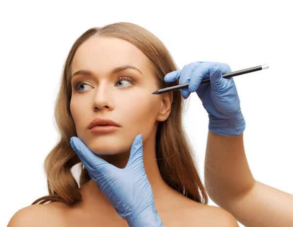 Woman face and beautician hands with pencil — Stock Photo, Image