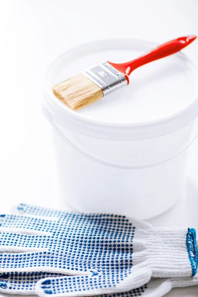 Paintbrush, paint pot and gloves — Stock Photo, Image