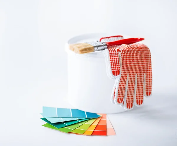 Paintbrush, paint pot, gloves and pantone samplers — Stock Photo, Image