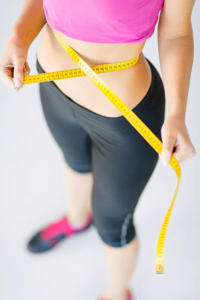 Trained belly with measuring tape — Stock Photo, Image