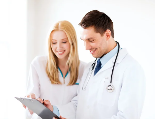 Two doctors writing prescription — Stock Photo, Image