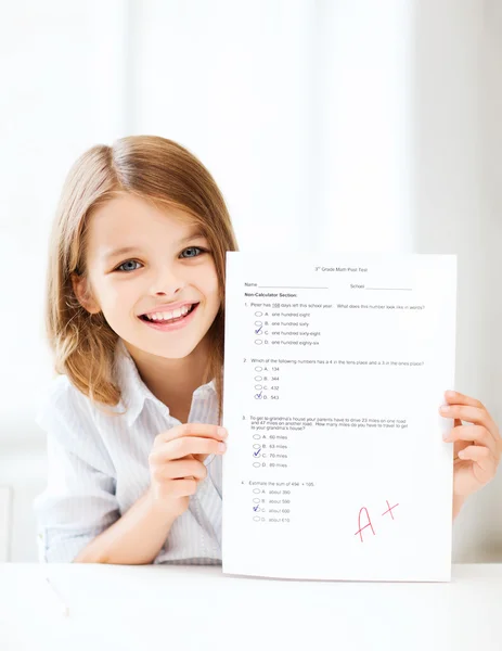 Girl with test and grade at school — Stock Photo, Image