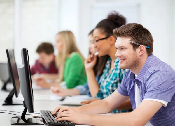 Students with computers studying at school — Stock Photo, Image