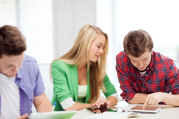 Students browsing in tablet pc at school — Stock Photo, Image